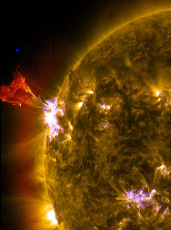 A burst of solar material leaps off the left side of the sun in what’s known as a prominence eruption. The blue dot is the size of Earth in comparison. This image combines three images from NASA's Solar Dynamics Observatory captured on May 3, 2013, at 1:45 pm EDT, just as an M-class solar flare from the same region was subsiding. The images include light from the 131-, 171- and 304-angstrom wavelengths. Credit: NASA/SDO/AIA
