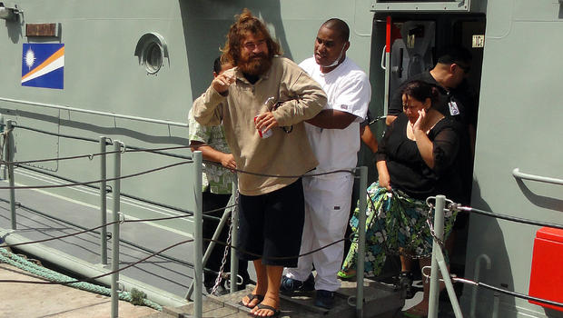 A castaway from Mexico who identified himself as Jose Salvador Alvarenga steps off the "Lomor" Sea Patrol vessel in Majuro, Marshall Islands, with the help of a nurse