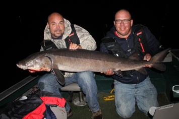 Tom with the help of his good friend Marty holding the 61" sturgeon.