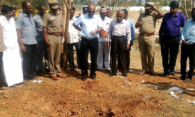 Indian authorities inspect the site of a suspected meteorite landing on February 7, 2016 in an impact that killed a bus driver and injured three others on February 6. If proven, it would be the first such death in recorded history. The impact of the object left a large crater in the ground and shattered window panes in a nearby building, killing the driver who was walking past. AFP PHOTOSTR/AFP/Getty Images